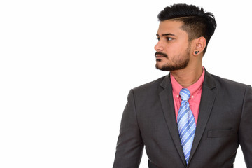 Side view of young handsome Indian businessman