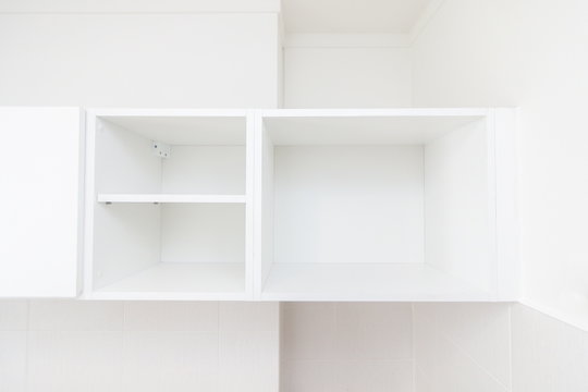 white book shelf box , minimal furniture empty space .