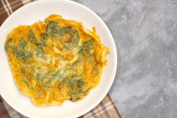 Top view of Omelette (Omelet) with dill served on white plate. Vegetarian. Still life food. Copy space.