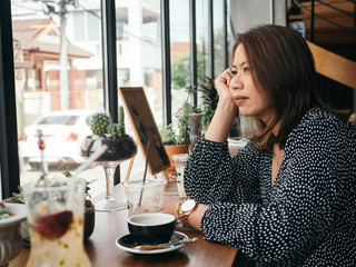 Asian woman relaxing at coffee shop, lifestyle concept.