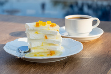 Curd cheese with lemon jam and cup coffee on table. Breakfast concept