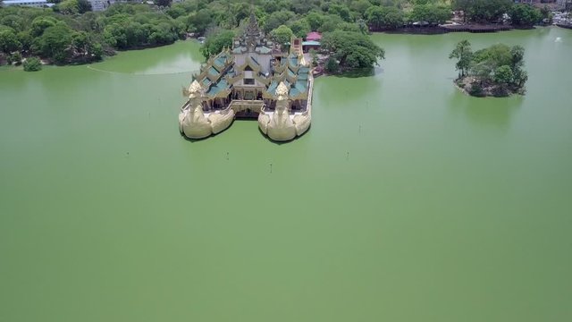 Begyoke Park in downtown Yangon , Myanmar.  Also known as Rangon, Burma.  The double dragon palace in the park over the green lake