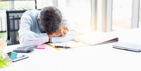 The businessman sat down at the desk in the office with a tissue on hand after the stock market...