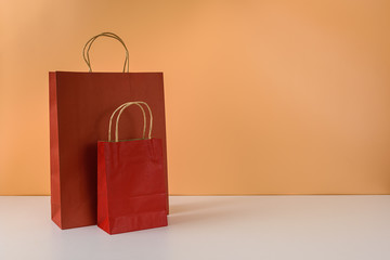 mockup of blank craft package or colorful paper shopping bag with handles