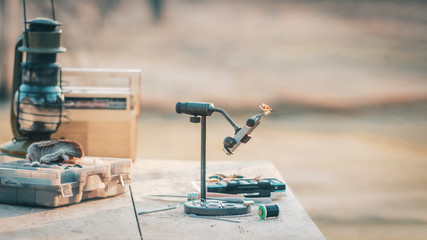 Knitting flies for fishing salmon. Fly fishing.