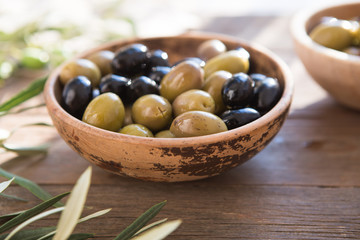 bowls with different kind of olives : green black kalamata olives with olive oil