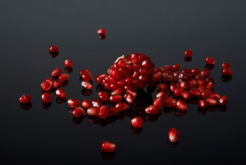 pomegranate seeds  on black background.