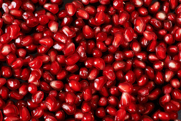 pomegranate seeds on black background.