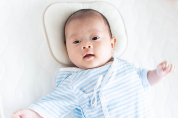 Baby lying on a crib