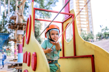 Boy enjoying time in a rope structure at adventure park