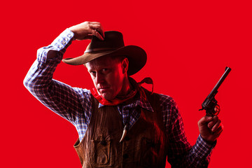 Portrait of farmer or cowboy in hat. American farmer. Portrait of man wearing cowboy hat, gun. Portrait of a cowboy. West, guns. Portrait of a cowboy. American bandit in mask, western man with hat