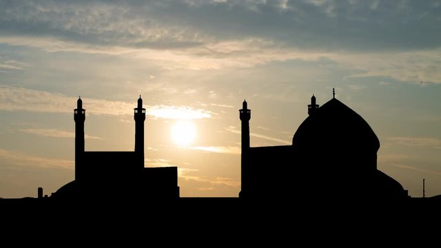 The Shah Mosque in Isfahan, Time Lapse at Sunrise with Coloful Clodus and Dark Silhouette, Iran