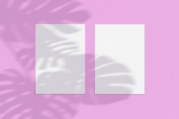 Blank white vertical paper sheet 5x7 on pink background with shadow overlay. Modern and stylish greeting card or wedding invitation mock up