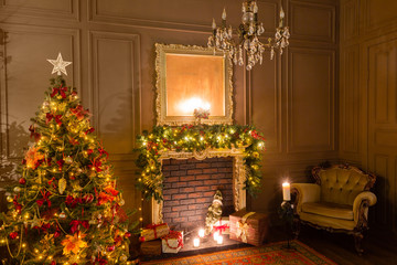 Christmas evening by candlelight. classic apartments with a fireplace, decorated tree, armchair.