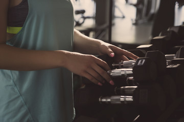Women using dumbbell in gym