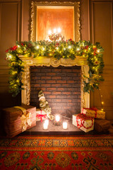 Classic apartments with a fireplace, decorated tree, armchair. Christmas evening by candlelight