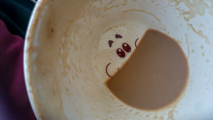 Happy face on the bottom of the coffee cup