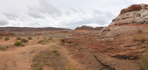 Lake Powell and arizona desert landscape with layered solid red rock strata formation