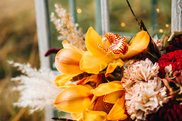 Set of autumn wedding decor outdoors. Floral arrangement of flowers. Details of the wedding...