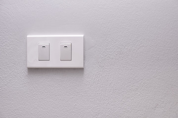 Electricity switch or lamp switch on white wall