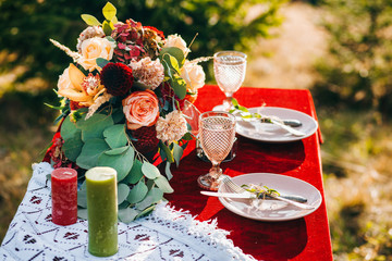 Vintage glass in boho style on the table of newlyweds