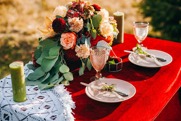 Newlyweds table decorated in rustic style on a background of autumn mountains