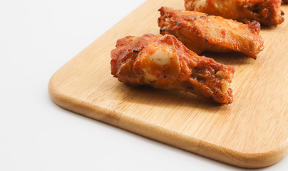 barbecue chicken wing on wooden chopping white background 