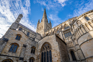 3 A medieval Norman cathedral against a bright blue sky full of white clouds