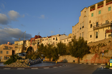 Fototapeta premium Houses overlooking the port of Termoli where fishing boats dock, is located on the Adriatic Sea in Molise - Italy