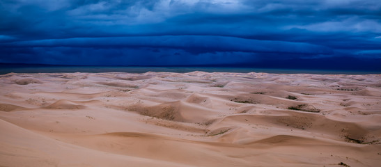 Storm clouds over sand dunes in the desert