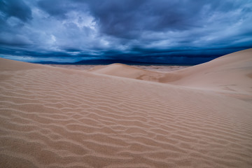 Storm clouds over sand dunes in the desert