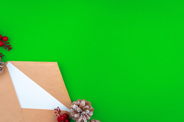 Desk with envelope and Christmas decorations. Flat lay. Mockup