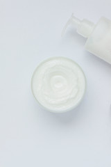 BODY CREAM WITH CLEANSING MILK BOOT ON WHITE BACKGROUND