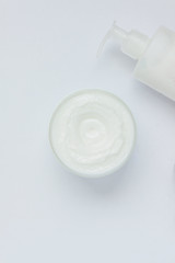 Fototapeta premium BODY CREAM WITH CLEANSING MILK BOOT ON WHITE BACKGROUND