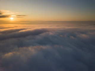 Fototapeta na wymiar View above clouds during sunrise. Dramatic view the sky.