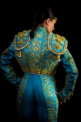 Woman bullfighter suit with blue lights on a black background