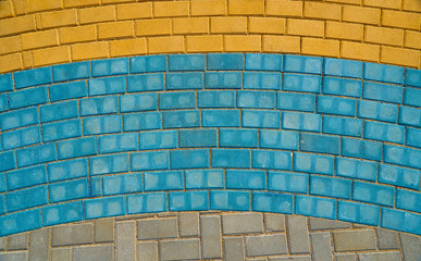 grey, yellow and blue paving tiles for background or texture