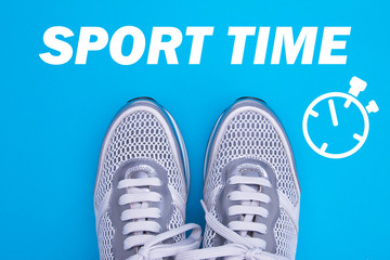 Sneakers top view. Sports sneakers and stopwatch on a blue background. Sports time concept.