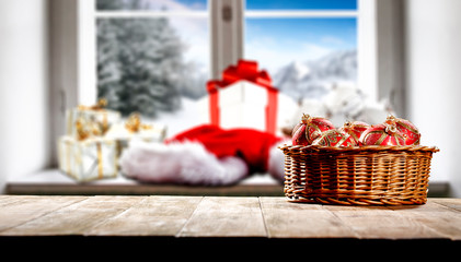 Christmas decorations in bright colors with blurred snowy winter outside the window background.