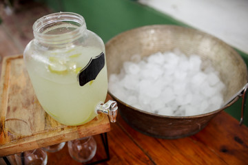 lemonade dispenser next to bucket with ice