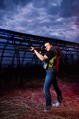 Soldier with weapons at night outdoors. Guy military instructor during a military exercise dark night