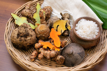Herbs ingredients in bamboo basket for override the salt pot compress, Thai traditional medicine hot compress therapy. Thai herb such as  turmeric, Phlai for massage therapy alternative medicine.