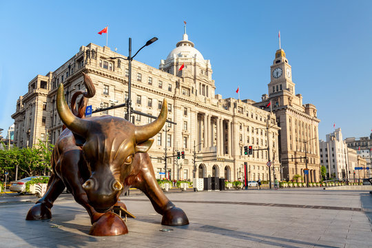 Shanghai, China - May, 2019: Bronze bull on The Bund in Shanghai, Iron bull statue in front of Chinese banks on the Waitan Bund promenade, Shanghai