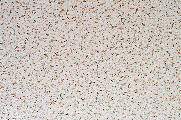 Abstract texture with splashes of orange and green.