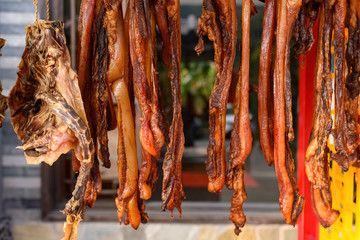 air-dried bacon and duck hanging on shelf