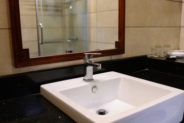 bathroom with white washbasin with chrome faucet in a hotel room