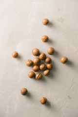 Superfood. Organic macadamia nut on stone background.