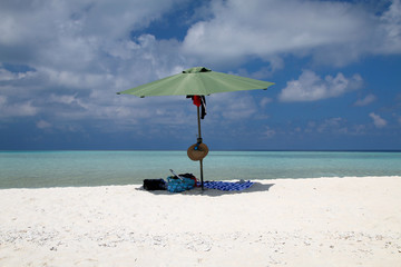 Fototapeta na wymiar beach umbrella on a deserted beach on the island.