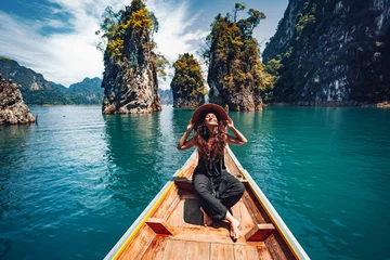 Fotobehang happy young woman tourist in asian hat on the boat at lake © zolotareva_elina