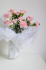 Carnations flower in the glass vase.